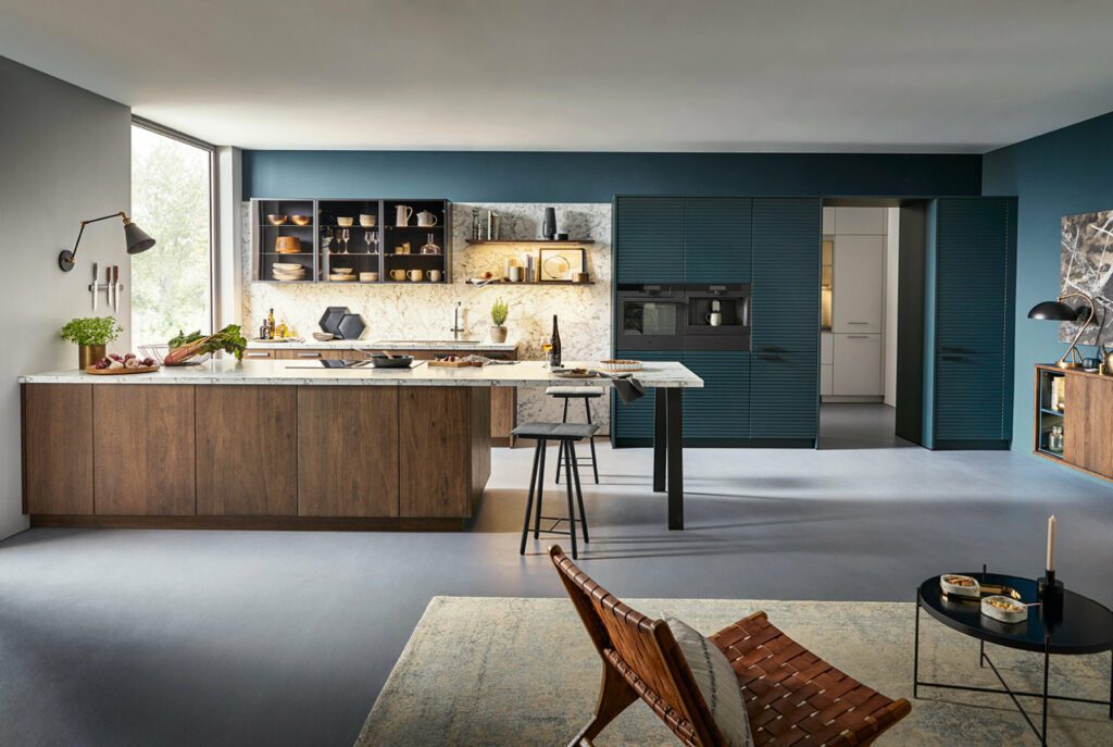 Schuller Vibrant Teal Wood Open Plan Kitchen | Sia Kitchens, Hertfordshire